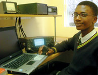Katlego and his new laptop, presented to him at the National Amateur Radio Centre in early December